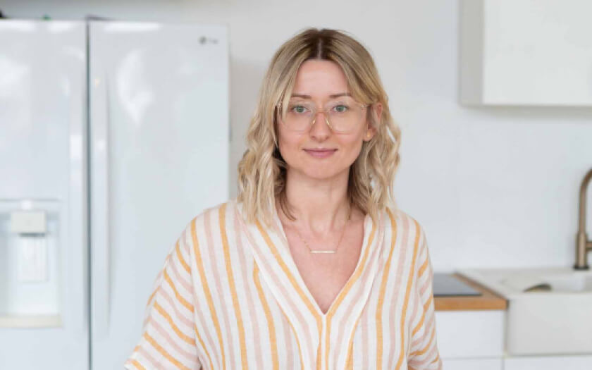 Juice Me owner Agata Robb sitting in her kitchen.